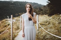 Tender brunette woman in dress posing on nature — Stock Photo
