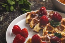 Close up view of homemade waffle with cream raspberries and chocolate strawberries. — Stock Photo