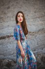 Tendre fille brune en robe bleue sur un terrain rocheux — Photo de stock