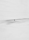 Minimalistic shot of person standing in sand landscape — Stock Photo