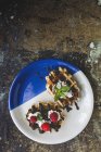 Diretamente acima waffle caseiro com framboesas creme e morangos de chocolate . — Fotografia de Stock