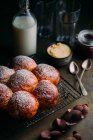 Still life of brioche with icing sugar, with bottle of milk and utensils at background — Stock Photo