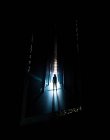Creepy silhouette of person standing in dark hallway. — Stock Photo