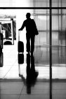 Tourist steht mit Koffer auf Bahnhof. — Stockfoto