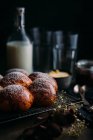 Close up view of brioche with icing sugar and kitchenware at background — Stock Photo