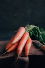 Fresh carrots on wooden cutting board — Stock Photo