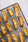 Fresh cantuccini biscuits on baking grid — Stock Photo