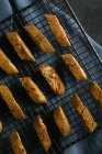 Homemade cantuccini biscuits on baking grid — Stock Photo