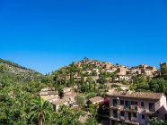 Panoramic view to small houses on hill over blue sky — Stock Photo