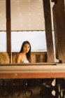 Молода жінка дивиться на камеру в сарай з сіном — стокове фото