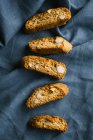 Row of fresh cantuccini biscuits on fabric — Stock Photo