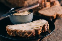 Close up view of rustic bread with butter — Stock Photo