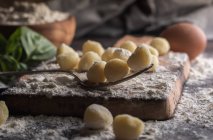 Close up view of raw gnocchi on wooden board — Stock Photo