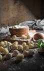 Still life of raw gnocchi and ingredients on table — Stock Photo