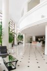 Interior of big hall with potted plants in hotel — Stock Photo