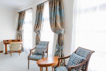 Blaue Stühle im hellen Hotelzimmer. — Stockfoto