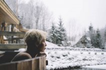 Portrait of blonde woman relaxing in plunge tub in winter outdoor — Stock Photo