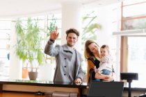 Young family with son at hotel reception — Stock Photo
