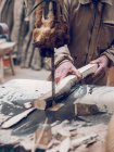 Crop artisan working with wood at workshop — Stock Photo