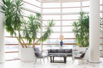 Chairs and table by potted plants at hotel lobby — Stock Photo
