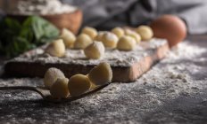 Close up view of raw gnocchi on fork at table — Stock Photo