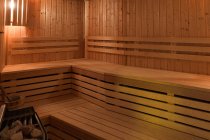 Interior view of wooden sauna with seats — Stock Photo