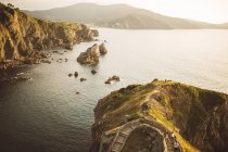 Aerial view to coastal cliffs and rocks at seaside in evening. — Stock Photo
