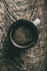 Directly above view of coffee mug on rustic wooden table — Stock Photo
