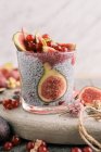 Glass of chia smoothie with coconut milk and figs on table — Stock Photo