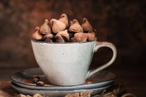 Close up view of chocolate truffles in cup — Stock Photo