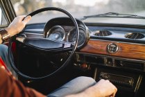 Crop male hand on steering wheel of retro car. — Stock Photo