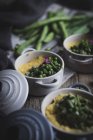 Ceramic bowls with polenta and peas — Stock Photo