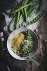Directly above plate with polenta and peas on rustic table — Stock Photo
