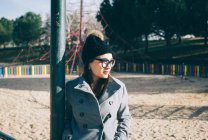 Pretty woman in glasses posing on playground — Stock Photo