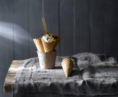 Still life of ice-cream cones in mug on rustic table — Stock Photo