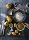 Ingredients for sweet pear cake arranged on wooden board. — Stock Photo