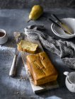 Freshly baked pear cake on rustic cutting board — Stock Photo