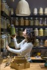 Woman taking jar with spice — Stock Photo