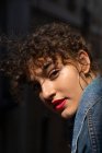 Curly young woman with red lips — Stock Photo