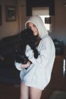 Woman holding black dog — Stock Photo