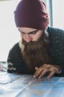 Bearded man looking at map — Stock Photo