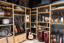 Shelf with drums and guitars — Stock Photo