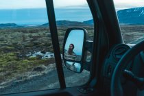 Reflection of bearded man in rear-view mirror — Stock Photo