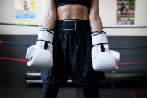 Faceless woman in sport wear staying in gym with professional equipment — Stock Photo