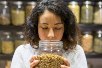 Woman smelling spices — Stock Photo