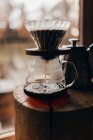Coffee pouring to glass jug — Stock Photo