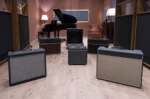 Conjunto de amplificadores perto do piano — Fotografia de Stock