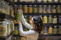 Woman taking jar with spice — Stock Photo