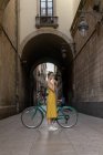 Woman standing with vintage bicycle — Stock Photo