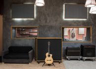Acoustic guitar near amplifier — Stock Photo